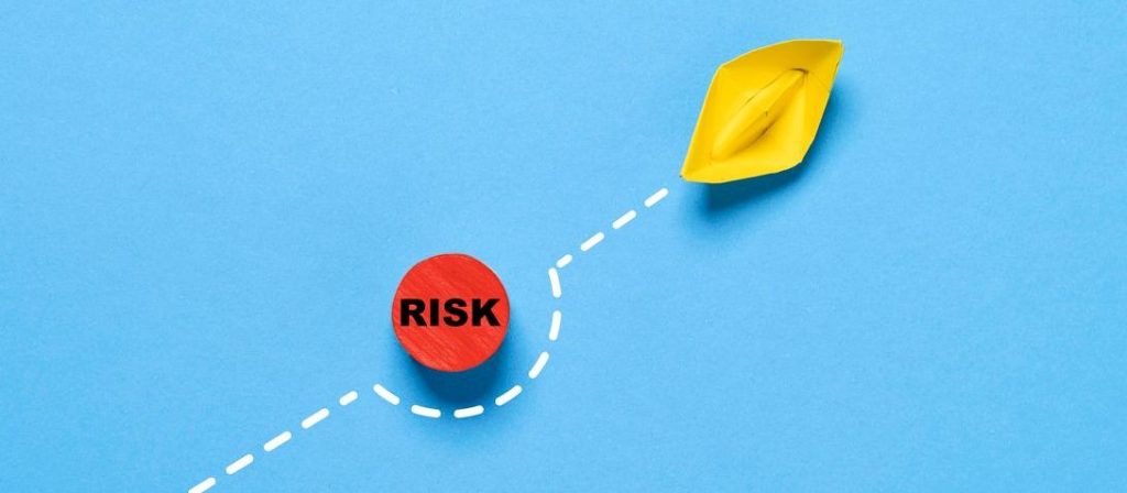yellow-paper-boat-sails-away-from-the-red-risk-danger-on-blue-ocean-licensure